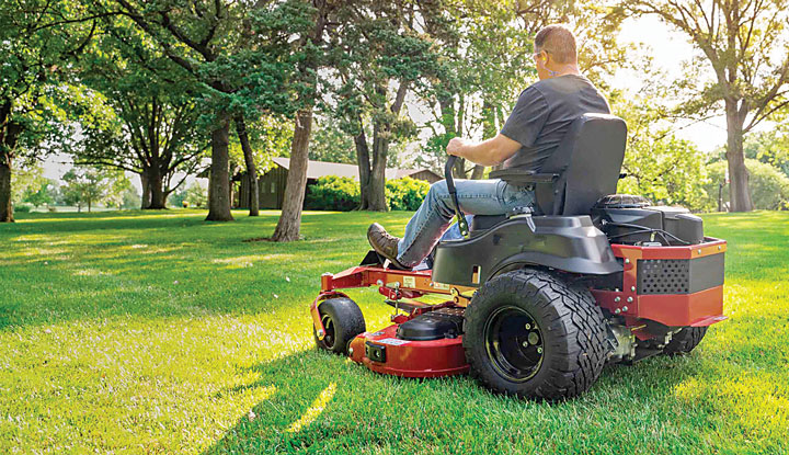 Riding mower in large grassy area